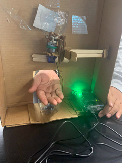 Figure 4. Automatic dispenser project using the built-in brightness sensor to turn on an RGB LED and turn a motor to dispense beans.